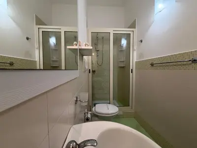 a white bathroom with a toilet and a sink at Casa Finuzza in San Vito lo Capo
