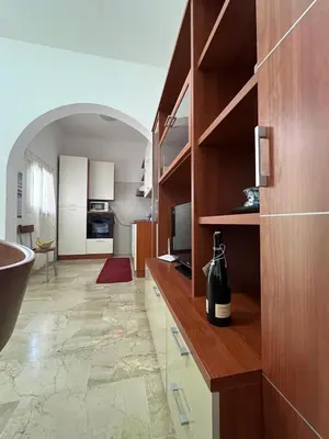 a kitchen with a counter with a bottle of wine at Casa Finuzza in San Vito lo Capo