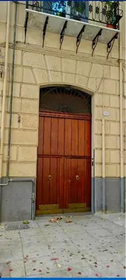 a large wooden door in the front of a building at Casa Amarilla in Palermo