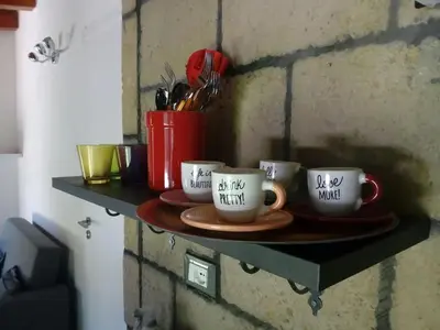a shelf with three coffee mugs on it at Loft Mondello Beach in Palermo