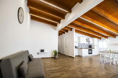 a living room with a couch and a dining room at Quattro Canti in Carini