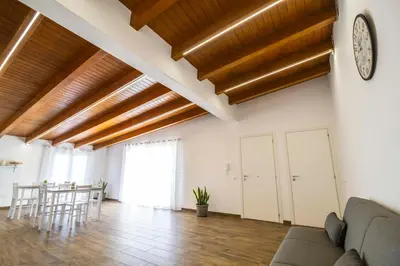 a living room with wooden ceilings and a clock on the wall at Quattro Canti in Carini