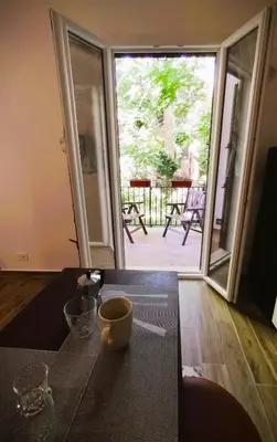 a kitchen with a sliding glass door to a patio at Domus Vetriera in Palermo