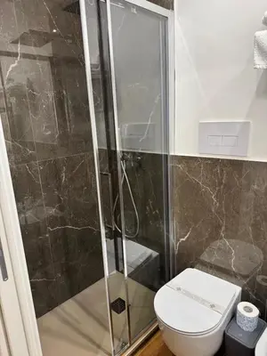 a bathroom with a shower and a toilet at Villareale47 Luxury Suites & Rooms in Palermo