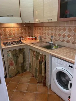 a kitchen with a sink and a washing machine at PANORAMIC VIEW - Sabrina's house in Altavilla Milicia