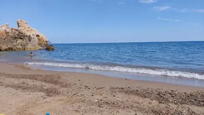 a person standing in the water at the beach at PANORAMIC VIEW - Sabrina's house in Altavilla Milicia