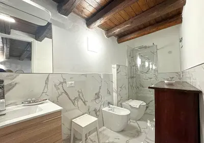 a bathroom with a toilet and a sink at Solemar Sicilia - Casa Enrica in Palermo