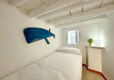a small bedroom with a bed in a room at Solemar Sicilia - Casa Enrica in Palermo