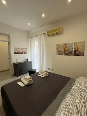 a bedroom with a bed with two towels on it at House of joy in Corleone
