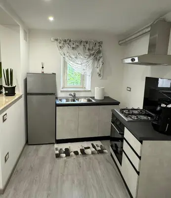 a kitchen with a refrigerator and a stove and a sink at House of joy in Corleone