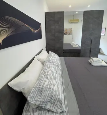 a bedroom with a bed and a mirror at House of joy in Corleone
