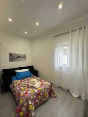a bedroom with a bed and a window at House of joy in Corleone