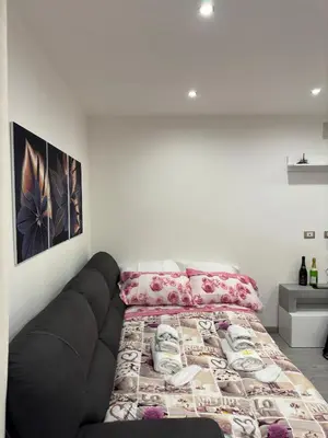 a bed with a black couch in a room at House of joy in Corleone