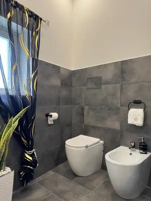 a bathroom with a toilet and a sink at House of joy in Corleone