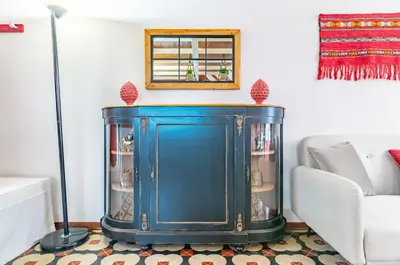 a blue cabinet in a living room next to a couch at GuestHost - The Traveller's House - Palermo Station Apartments in Palermo