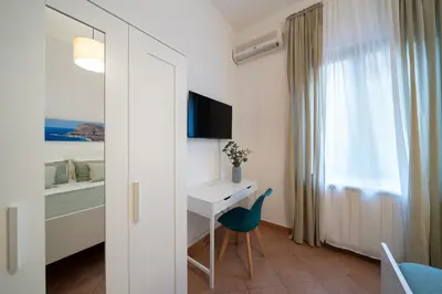 a room with a desk and a bed and a window at Palermo e Dintorni - Valentino Apartment in Palermo