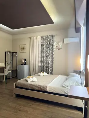 a bedroom with a bed with two towels on it at BIBI rooms and suite in Palermo