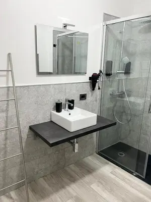 a bathroom with a sink and a shower at BIBI rooms and suite in Palermo