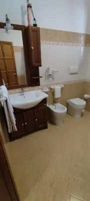 a bathroom with a sink and a toilet at Appartamento Arancio in San Vito lo Capo