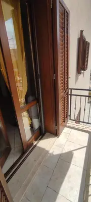 an open door of a building next to a balcony at Appartamento Arancio in San Vito lo Capo