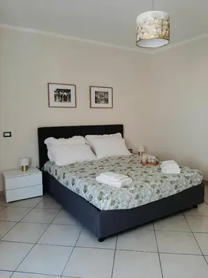 a bedroom with a bed in a white room at Stella del Centro Apartment in Palermo
