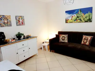 a living room with a couch and a table at Stella del Centro Apartment in Palermo