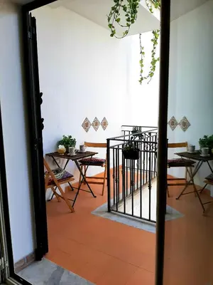 an open door to a dining room with tables and chairs at Stella del Centro Apartment in Palermo