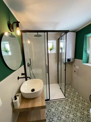a bathroom with a shower and a white sink at Calvello studio apartment in Palermo