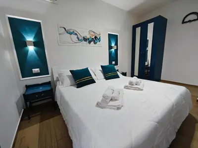 a bedroom with a large white bed with towels on it at Profumo di casa in Lascari