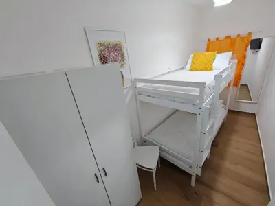 a small room with a bunk bed and a refrigerator at Profumo di casa in Lascari