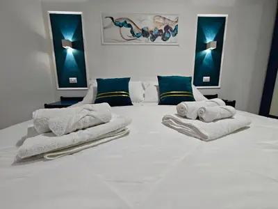 a bedroom with a white bed with towels on it at Profumo di casa in Lascari