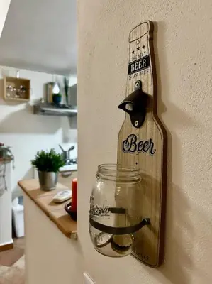 a bottle of beer hanging on a wall in a kitchen at Carmine House in Monreale