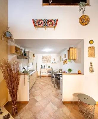 a kitchen and living room with a table and chairs at Carmine House in Monreale