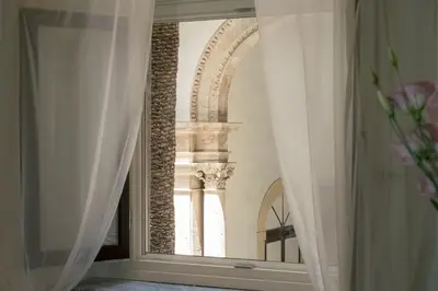 a view of a building through a window at Palazzo Santa Ninfa - Luxury Mansion in Palermo