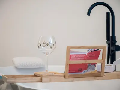 a wine glass and a book on a table at Palazzo Santa Ninfa - Luxury Mansion in Palermo
