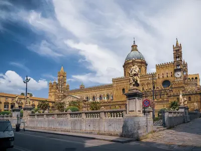 a large building with a clock tower on top of it at Palazzo Santa Ninfa - Luxury Mansion in Palermo