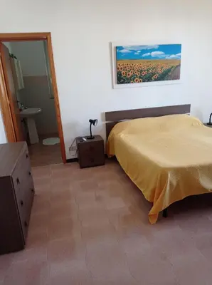 a bedroom with a bed and a dresser and a mirror at Villa Rosa Bella Vista Balestrate in Balestrate