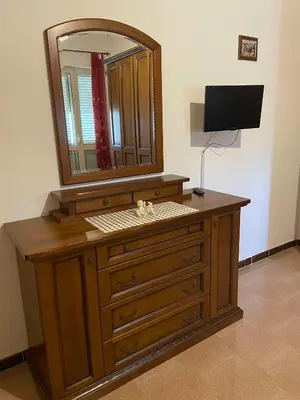 a dresser with a mirror and a television on it at Villa Rosa Bella Vista Balestrate in Balestrate