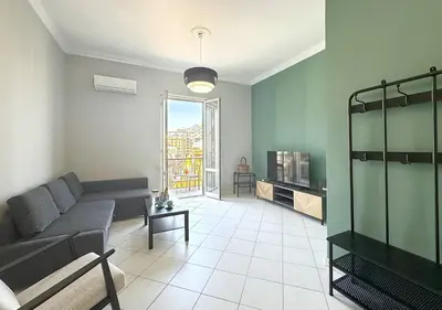 a living room with a couch and a tv at Solemar Sicilia - Casa Scordia in Palermo