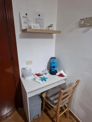 a small white desk with a blue toy on it at Le stanze di Aurora in Palermo