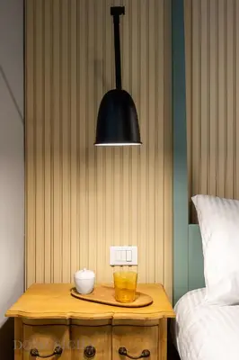 a table with a black lamp and a glass on it at Constance Luxury Apartment by DomuSicily in Palermo