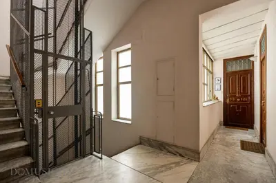 an empty hallway with a door and a staircase at Constance Luxury Apartment by DomuSicily in Palermo