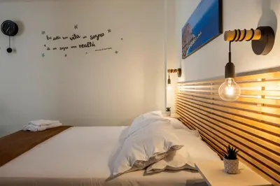 a bedroom with a bed and a sign on the wall at Al Borghetto marinaro in Palermo