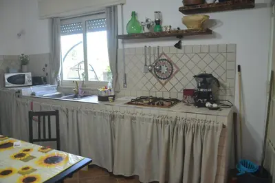 a kitchen with a counter top and a stove at Villino Anna e Pippino in Calatafimi