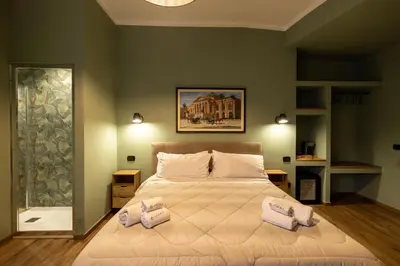 a bedroom with a large bed with two pillows on it at Le radici di Gallidoro in Palermo