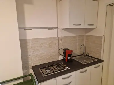 a small kitchen with a stove and a sink at Gianni House Palermo in Palermo