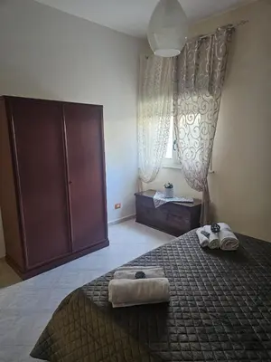 a bedroom with a bed with two towels on it at A casa di Livia in Villabate