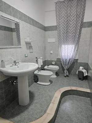 a bathroom with a sink and a toilet and a tub at A casa di Livia in Villabate