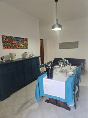 a dining room table with a blue and white table cloth at A casa di Livia in Villabate