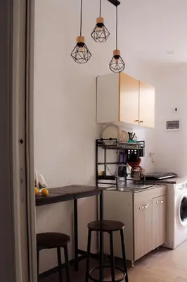 a kitchen with a counter and stools in it at Leone Guest House in Palermo